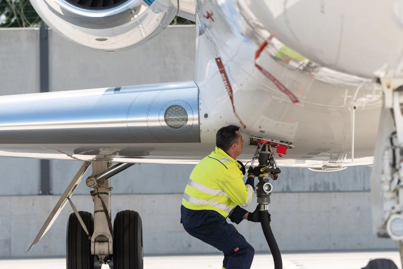 Technician fuelling a business jet
